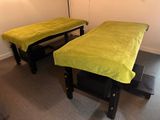 two beds in a room with a green cover on them