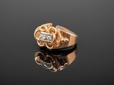 a close up of a gold ring with diamonds on a black surface