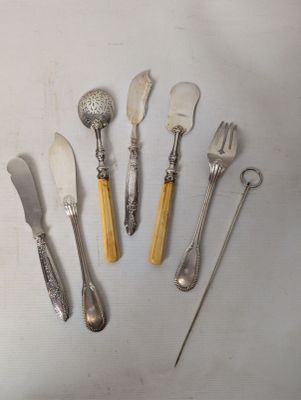 a lot of silverware on a table with spoons and forks