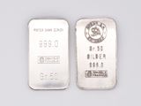 two silver bars are shown side by side on a white surface