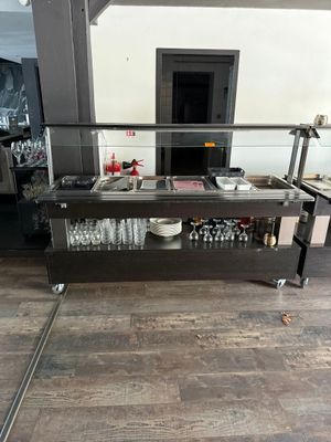 an image of a bar in a restaurant with a lot of wine glasses on the counter