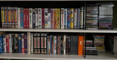 a book shelf with many dvds on it