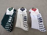 three pairs of socks with polka dots on them sitting on a couch