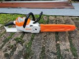 a close up of a chainsaw sitting on the ground