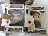 two pop vinyl figures of harry potter and hermione