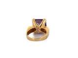 a close up of a ring with a purple stone in it