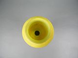 a yellow vase with a black hole in it