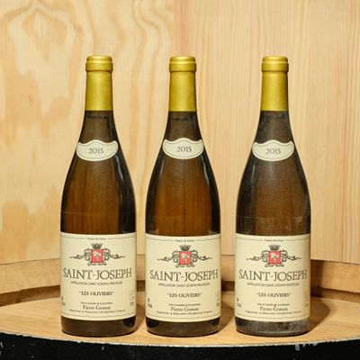 three bottles of wine sitting on top of a barrel