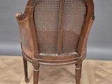a wooden chair with a cane back and a cane seat