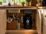 a kitchen with a sink and a coffee maker in it