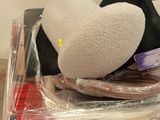a stuffed animal that is laying on top of a plastic bag