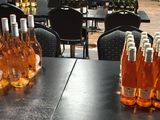 many bottles of wine sitting on a table in a room
