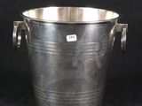 silver plated ice bucket with handles and handles on a black background