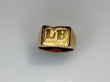 an image of a gold ring with the letter b on it