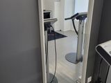 a large mirror in the corner of a room with a treadmill
