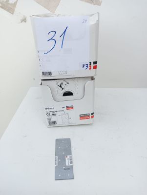a stack of boxes sitting on top of a table next to a ruler