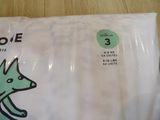 a bag of dog diapers on a wooden table