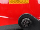 a close up of a red helmet with a yellow sticker on it