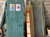several pieces of wood are stacked on the floor next to a green door