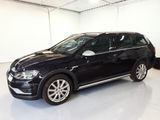 the black volkswagen suv is parked in a white room