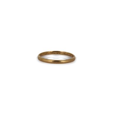 gros plan d'une bague en or sur fond blanc