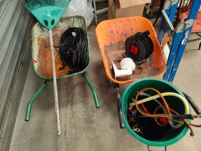 two buckets and a rake sitting next to each other