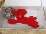 a red keychain with the word love in the middle of it