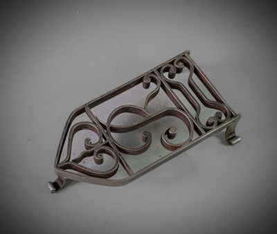 a close up of a metal object on a white surface