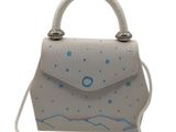 Le petit sac à main blanc est orné d'un motif bleu et blanc.