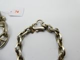 a silver bracelet and a silver bracelet on a table