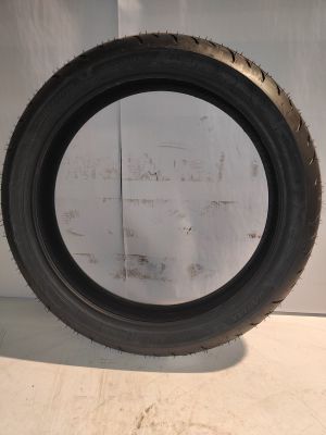 a close up of a tire on a white surface with a white wall in the background