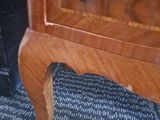 a wooden cabinet with a drawer on top of it