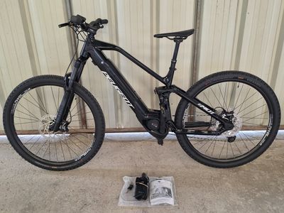 a bike that is sitting on the ground next to a pair of shoes