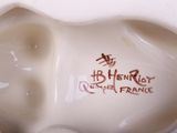 porcelain figurine of a white elephant with red writing on it ' s face