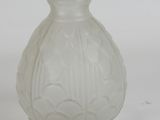 a glass vase that is sitting on a white surface