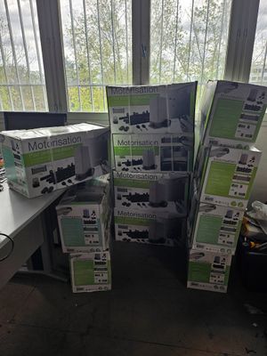 a pile of boxes sitting on a desk in front of a window