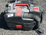 a black and red blower sitting on the ground