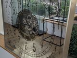 a clock on display in a glass case in a room