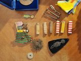 a table with a bunch of medals and other items on it