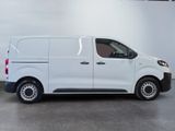 the white van is parked in a large room with a gray floor