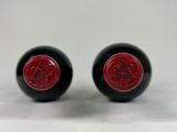 two black and red knobs with a red logo on them