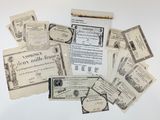 a pile of old papers and old money on a table