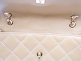 the inside of a white purse with a chain on the handle