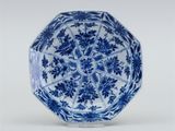 a blue and white octagonal bowl with floral design