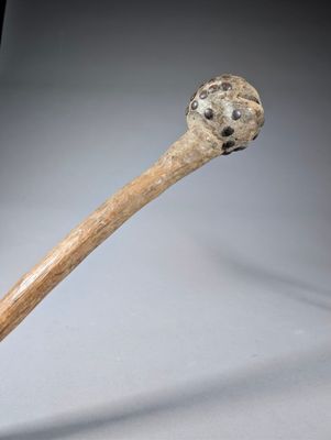 a wooden stick that has a ball on top of it