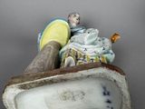 a figurine of a man and a woman in a boat