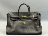 a grey leather handbag with gold hardware on the handle
