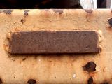 rusted piece of luggage sitting on top of a wooden table