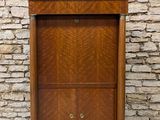 an old wooden cabinet with two doors and a drawer underneath it
