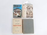 three books are sitting on a white surface next to each other